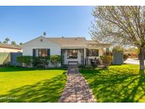 Charming single-story home with white exterior, manicured lawn, and inviting walkway at 345 W Wilshire Dr, Phoenix, AZ 85003