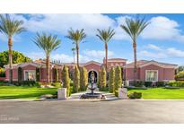 Charming single-story home featuring mature palms, manicured landscaping, and a decorative water fountain at 3937 E Norcroft Cir, Mesa, AZ 85215