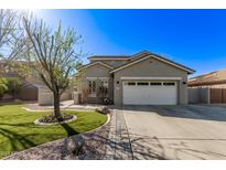 Charming home with a two-car garage, well-maintained lawn, and mature landscaping at 4171 E Dublin Ct, Gilbert, AZ 85295