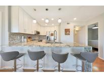 Modern kitchen featuring granite countertops, white cabinets and stainless steel appliances at 4850 E Desert Cove Ave # 333, Scottsdale, AZ 85254
