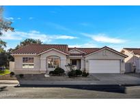 Charming single-story home featuring a well-manicured front yard, tile roof, and an attached two-car garage at 7038 N 28Th Ave, Phoenix, AZ 85051