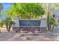 Attractive SoVanna entrance sign landscaped with colorful flowers and small palm trees on a clear, sunny day at 11000 N 77Th Pl # 1072, Scottsdale, AZ 85260