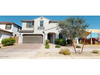 Charming two-story home with a well-manicured front yard and a two-car garage, near a neighborhood playground at 14420 W Faye Way, Surprise, AZ 85387