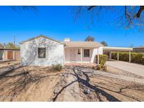 Charming single-story home with a light-colored exterior and a convenient covered carport at 1716 W Weldon Ave, Phoenix, AZ 85015