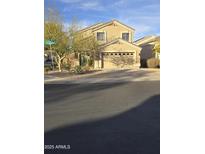 Inviting two-story home featuring a two car garage, manicured landscaping, and charming curb appeal at 21748 W Sonora St, Buckeye, AZ 85326