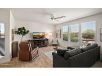 Bright living room with hardwood floors, modern furniture, and large windows offering natural light at 2425 W Bronco Butte Trl # 2030, Phoenix, AZ 85085