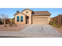 Charming single-story home featuring desert landscaping, a tile roof, and an attached two-car garage at 41124 W Rio Bravo Dr, Maricopa, AZ 85138