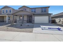 Inviting two-story home featuring a neutral-toned facade, covered porch, and attached two-car garage at 4133 W Eli Dr, San Tan Valley, AZ 85144