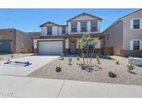 Two story home featuring a two-car garage, neutral color palette, and a low maintenance desert landscape at 4169 W Eli Dr, San Tan Valley, AZ 85144