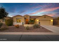 Charming single-story home with desert landscaping, neutral tones and a two car garage at 42920 W Kingfisher Dr, Maricopa, AZ 85138