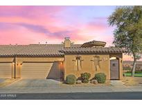 Charming single-story home with a tile roof, stucco walls, and a well-manicured front yard with lush landscaping at 4528 W Valencia Dr, Laveen, AZ 85339