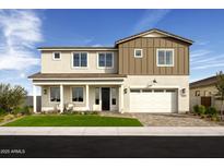 Beautiful two-story home featuring a two-car garage, covered front porch and well-manicured lawn at 5711 S Quartz St, Gilbert, AZ 85298