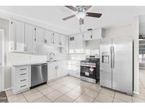 Bright kitchen with stainless steel appliances and white cabinets, offering ample storage space at 6808 N 33Rd Ave, Phoenix, AZ 85017