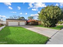 Charming single-story home boasts a large lawn, attached two-car garage, and beautifully manicured landscaping at 7334 N 7Th Ave, Phoenix, AZ 85021