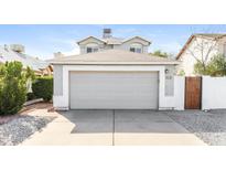 Attached two-car garage with a driveway for additional parking at 7559 W Turquoise Ave, Peoria, AZ 85345