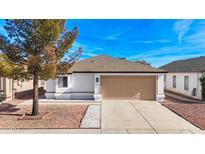 Charming single-story home with a well-maintained front yard and an attached two-car garage at 8567 N 107Th Dr, Peoria, AZ 85345