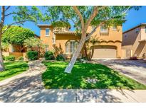Beautiful two story home with a well-manicured lawn, mature trees and a two car garage at 1152 W Horseshoe Ave, Gilbert, AZ 85233