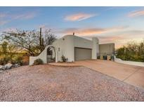 Desert home featuring stucco siding, an attached garage, beautiful desert landscaping and a desert view at 16410 E Leo Dr, Fountain Hills, AZ 85268