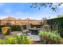 Inviting backyard patio with comfortable seating, fire pit, and mountain views for outdoor relaxation and entertainment at 17991 N 95Th St, Scottsdale, AZ 85255