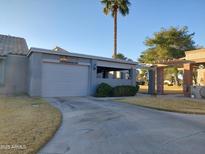 Charming single-story home with a private driveway, desert landscaping, and a covered patio area at 276 Leisure World --, Mesa, AZ 85206
