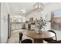 Elegant kitchen featuring white cabinetry, stainless steel appliances, and a cozy breakfast nook at 3027 N 83Rd Pl, Scottsdale, AZ 85251