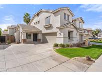 Two-story home featuring a three car garage, desert landscaping, and a welcoming entrance at 3794 S Laurel Way, Chandler, AZ 85286