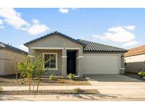 Charming single-story home featuring a well-manicured front yard and a two-car garage, perfect for suburban living at 42890 W Peters Dr, Maricopa, AZ 85138