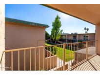 A view from the balcony overlooking the grassy courtyard in the community at 6565 N 19Th Ave # 37, Phoenix, AZ 85015