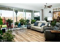 Bright living room with hardwood floors and sliding glass doors leading to the backyard at 808 E Constance Way, Phoenix, AZ 85042