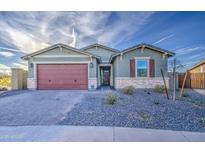 Charming single-story home featuring a well-manicured front yard, brick accents, and attached two-car garage at 8420 S 69Th Ln, Laveen, AZ 85339