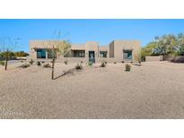 Stunning modern home featuring desert landscaping and a welcoming facade, with a neutral color palette at 8730 E Tether Trl, Scottsdale, AZ 85255