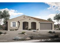 Charming single-story home showcasing a desert landscape, arched entryway, and attached two car garage at 17422 W Via Dona Rd, Surprise, AZ 85387