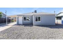 Charming single-story home with neutral paint, gravel landscaping, and covered parking space at 2027 W Monte Vista Rd, Phoenix, AZ 85009