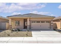 Charming single-story home featuring a tile roof, neutral stucco, stone accents, a two-car garage, and low-maintenance landscaping at 24577 W St Anne Ave, Buckeye, AZ 85326