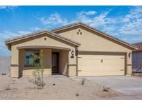 Charming single-story home featuring a two-car garage and low maintenance desert landscaping in the front yard at 24577 W St Anne Ave, Buckeye, AZ 85326