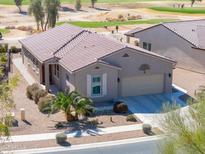 Charming single-story home with desert landscaping, tile roof, and attached two-car garage near the golf course at 2643 E San Ricardo Trl, Casa Grande, AZ 85194