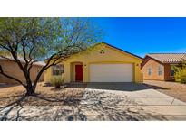 Charming single-story home with a well-manicured yard, desert landscaping, and a red front door at 2725 W Silver Creek Ln, San Tan Valley, AZ 85144