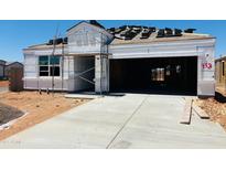 New construction home featuring an attached two car garage and the roof is under construction at 28200 N Nealite Dr, San Tan Valley, AZ 85143
