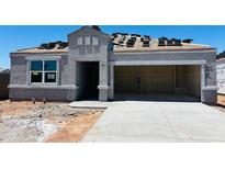 Unfinished exterior of a home under construction with stucco and dark roofing tiles at 28200 N Nealite Dr, San Tan Valley, AZ 85143