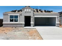 View of a stucco home with stacked roof tiles and large garage at 28200 N Nealite Dr, San Tan Valley, AZ 85143