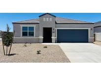Charming single-story home featuring a well-manicured front yard, covered entryway, and attached two-car garage at 28200 N Nealite Dr, San Tan Valley, AZ 85143