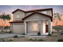 Inviting two-story home with a tile roof, attached garage, and manicured front yard, blending comfort and curb appeal at 42860 W Peters Dr, Maricopa, AZ 85138
