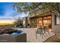 Charming back patio features a spa, outdoor seating, and a built-in BBQ with views of the beautiful Arizona landscape at 10767 E Santa Fe Trl, Scottsdale, AZ 85262