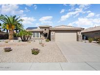 Charming single-story home with desert landscaping, a tile roof, and an attached two-car garage at 15542 W Cypress Point Dr, Surprise, AZ 85374