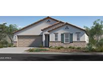 Charming single-story home with a two-car garage, stone accents and well manicured front yard at 17143 W Oberlin Way, Surprise, AZ 85387