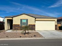 Charming single-story home featuring a two-car garage and well-maintained landscaping with desert accents at 18400 E Donato Dr, Gold Canyon, AZ 85118