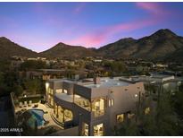 Stunning twilight aerial view of the property featuring a pool, fire pit, and mountain views at 24019 N 112Th Pl, Scottsdale, AZ 85255