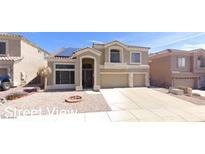 Inviting home showcasing neutral tones, well-manicured landscaping, and a spacious driveway at 25035 N 63Rd Dr, Phoenix, AZ 85083