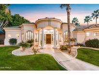 Charming home exterior displaying its beautiful entryway and professionally landscaped front yard at dusk at 3441 S Camellia Pl, Chandler, AZ 85248