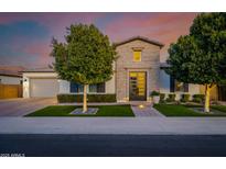 Charming home featuring brick accents, a multi-pane front door, manicured landscaping and mature trees at 4191 S Emerald Dr, Chandler, AZ 85249